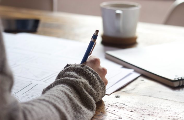 Person handwriting at a table